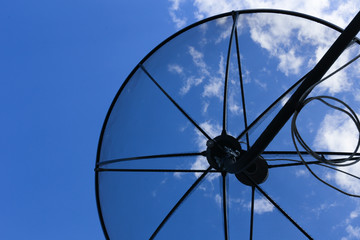 Satellite dish to the sky in blue sky background with tiny clouds