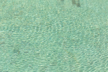 Green swimming pool rippled water detail