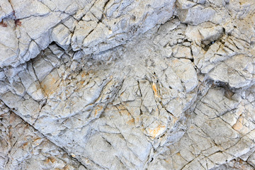 Rock texture and surface background. Cracked and weathered natural stone background.