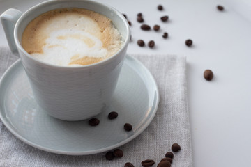 cup of cappuccino coffee on a napkin.