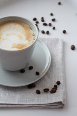 cup of cappuccino coffee in a cup on a white background.
