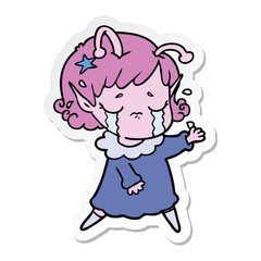 sticker of a cartoon crying alien girl