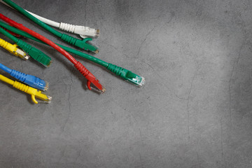 Close up multicoloured ethernet network cables  on gray background,Bunch of multicolored RJ45 cables,Top view.