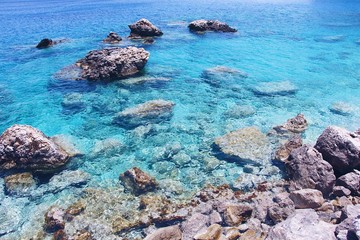 Rocks and clear ocean on Apella Beach, Karpathos Island, Greece