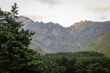 The main Caucasian ridge. Georgia, Kazbegi village (Stepantsminda).  Mountains, summer, twilight. Beautiful, amazing sky. High mountains. Vacation, hike.