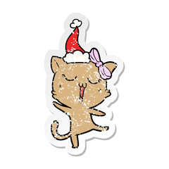 distressed sticker cartoon of a cat wearing santa hat