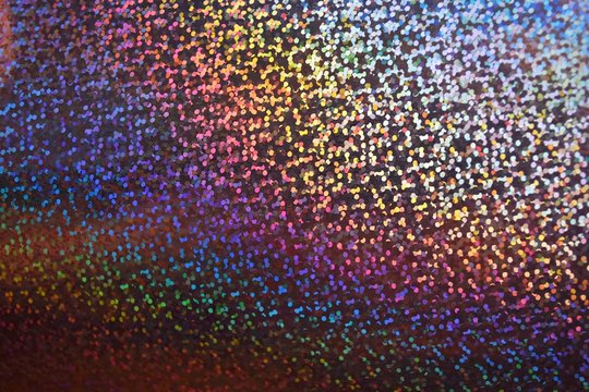 Abstract holographic texture background, shiny rainbow hologram paper, colorful backdrop.