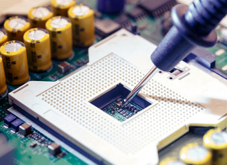 Close Up - Technician engineer measuring multimeter CPU socket computer motherboard (Technology...