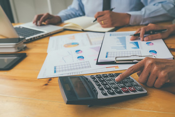 Business advisor analyzing financial figures denoting the progress Internal Revenue Service checking document. Audit concept