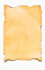 Old paper with burns and cleft marks on a white background
