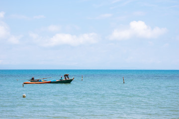 Local Fisherman Boats on the left side floating over the sea with bright sky in background in the afternoon at Koh Mak Island in Trat, Thailand.