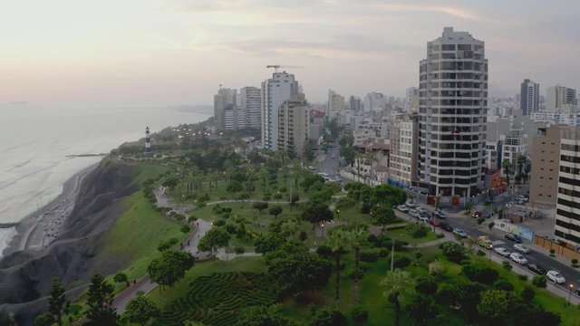 Aerial view of Miraflores's park by the ocean in Lima, Peru. People, tourists and cyclists having fun in "Malecon Costa Verde". Peruvian lifestyle.