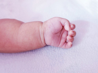 New born baby left hand side on white background and pink one