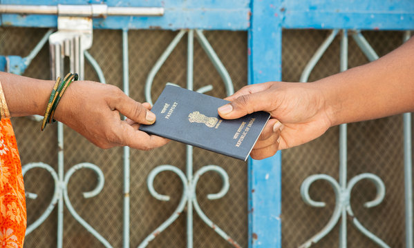 Concept of woemn receving passport at the door step of the house in India