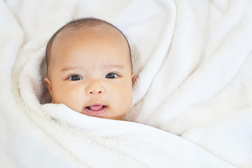 Newborn baby girl on white towel after done shower