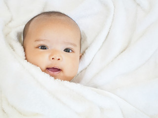 Newborn baby girl on white towel after done shower