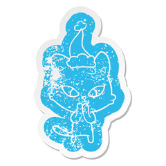 cute cartoon distressed sticker of a cat wearing santa hat