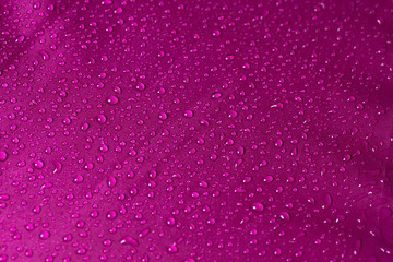 Close up water drop on the pink fabric