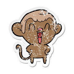 distressed sticker of a cartoon laughing monkey