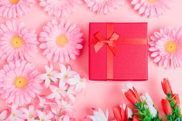 Flower and gift box on pink background