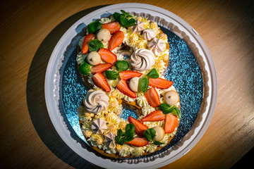 Light and fresh cake. Refined dessert made from meringue topped with low-fat whipped cream, mint leaves and strawberries
