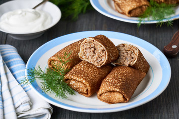 Pancakes stuffed with rice and meat on a plate