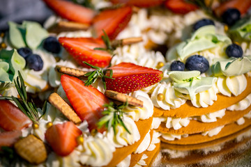 Light and fresh cake. Refined dessert made from meringue topped with low-fat whipped cream, mint leaves and strawberries