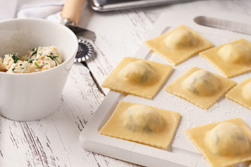 Raw uncooked ravioli with spinach and salmon filling.