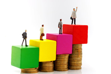 Miniature people:  Businessmen standing with coins stack, Finance, investment and growth in business concept.