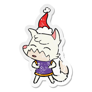distressed sticker cartoon of a fox wearing santa hat