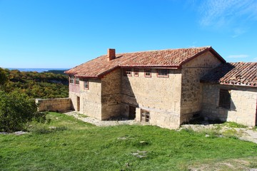 Fototapeta na wymiar Side view of a typical well-off karaite residential house in the cavecity Chufut-Kale near Bakhchisarai city on the Crimean Peninsula.