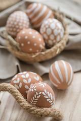 Happy Easter. Congratulatory easter background. Village eco-friendly eggs painted in white ornament for Easter day.