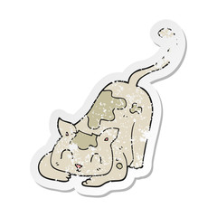 retro distressed sticker of a cartoon cat playing