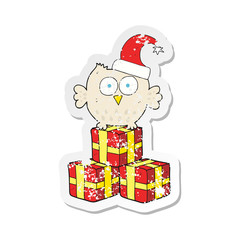 retro distressed sticker of a cartoon little owl wearing christmas hat
