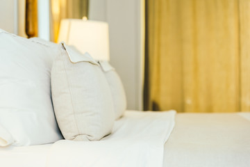 White pillow on bed decoration in beautiful luxury bedroom interior