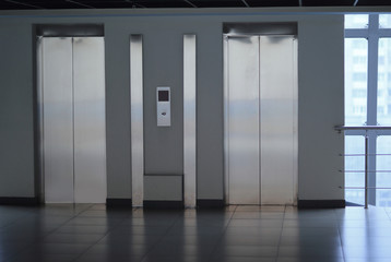 closed Elevator doors and control panel in a modern office building
