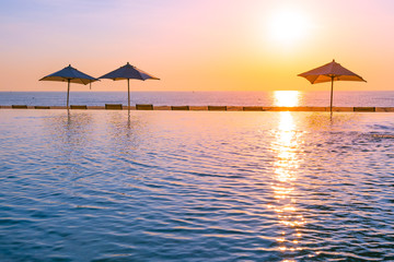 Beautiful landscape outdoor swimming pool with umbrella and deck chair in hotel resort for relax travel and vacation