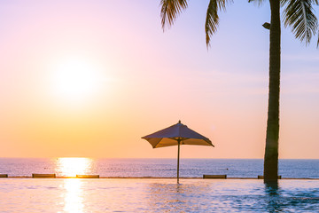 Beautiful landscape outdoor swimming pool with umbrella and deck chair in hotel resort for relax travel and vacation