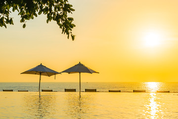 Beautiful landscape outdoor swimming pool with umbrella and deck chair in hotel resort for relax travel and vacation