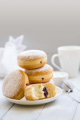 Traditional German Polish Donut with Raspberry Jam Dusted with Icing Sugar