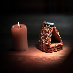 Christmas table. candle , oranges and cinnamon sticks on wooden
