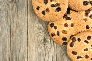 Oatmeal cookies with raisins,  on a dark wooden background