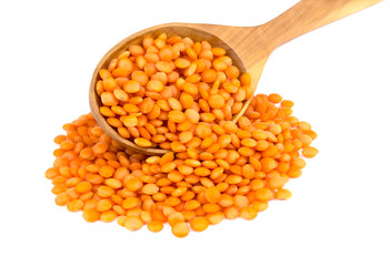Lentil  in wooden spoon isolated on white background