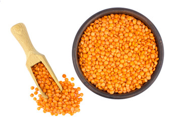 Red lentils in plate and scoop isolated on white background