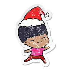 distressed sticker cartoon of a smug boy wearing santa hat