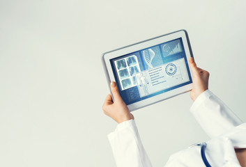 Close of female doctor hands working with tablet pc computer