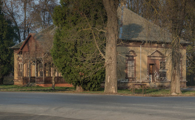 Old building in park at the fall time, rustic and falling apart from elapsed  time