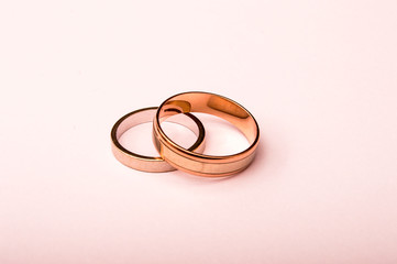 Rose and white gold engagement rings on white background.