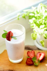 Strawberry smoothie or milkshake in jar on white rustic background, healthy food for breakfast and snack
