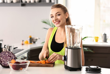 Young woman making healthy smoothie at home